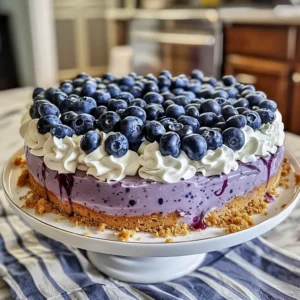 Delicious blueberry cheesecake on a white cake stand.