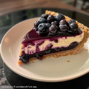 Slice of blueberry cheesecake with a graham cracker crust.